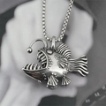 Artistic close-up of a vintage anglerfish pendant necklace made of silver steel - Pendant + Matching Chain