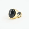 Golden ring featuring an oval black gemstone and Yin Yang symbol with white stones - Gold Setting Black Stone