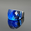 Exaggerated silver wide band ring featuring a large faceted blue sapphire gemstone - US 6 / Blue Rhinestone