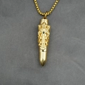 Golden bullet pendant necklace with baroque pattern and small black gemstone detail - Gold Tone Pendant With Chain