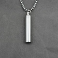 Polished silver cylinder capsule urn pendant with box chain on dark textured fabric - Silver Color Pendant with Chain
