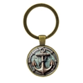 Vintage bronze anchor keychain with nautical motif in glass dome pendant on white background - Antique Bronze