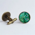 Detail of vintage bronze cufflinks with peacock feather glass dome and bullet back closure - Antique Bronze