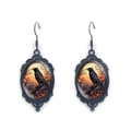 Gothic raven oval drop earrings with black floral frame and orange sunset scene detail - Sunset Crow Style (XSWX9044-10)