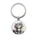 Playful kitten illustration on a round silver metal keychain for bags and keys - Silver