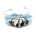 Detail of light blue leather braided bracelet with Yin Yang dragon glass cabochon - Blue