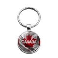Macro view of Canada flag key ring with maple leaf design and polished glass dome cover - CANADA Text Style (XSWX8417-11)