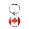 Detail of silver metal keychain with Canada flag maple leaf and red star graphic - Red Star Variant (XSWX8417-6)