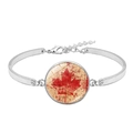 Detailed macro view of Canada flag glass cabochon on a vintage silver bangle bracelet - Retro Worn Texture Maple Leaf Style (XSWX8424-7)