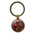 Vintage bronze keychain with red poppy flower relief on dark background and metal ring - Antique Bronze