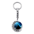 Rotating moon keychain featuring a howling wolf silhouette against a deep blue night sky - Wolf Howling on Peak (XSWX8432-6)