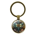 Vintage-Schlüsselanhänger aus Bronze mit Libellen-Glas-Cabochon und Blumen auf weißem Grund - Antikbronze