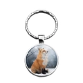 Macro detail of a glass cabochon fox keychain with a silver metal ring and snow fox image - Fox in Snow (XSWX7825-9)