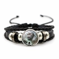Macro shot of multi-layer leather bracelet with Bigfoot silhouette glass cabochon charm - Bigfoot Avatar Style (XSWX7831-2)