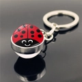 Cartoon ladybug keychain with red and black spotted pattern in a glass dome on black surface - Simple Red with Black Dots (XSWX4018-6)