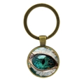 Llavero de bronce vintage con colgante místico de ojo de dragón en cristal y fondo blanco - Bronce Antiguo