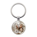 Portachiavi in metallo argentato con ciondolo fantasy leone e donna su sfondo bianco - Argento