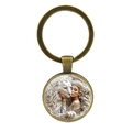 Portachiavi vintage in bronzo con cabochon in vetro e motivo fantasia leone bianco e donna - Bronzo Antico