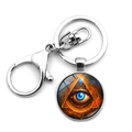 Detailed view of Egyptian Eye of Horus keychain with blue Eye of Providence glass pendant - Orange Red Flame Lava Style (XSWX8123-9)