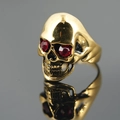 Golden skull ring with red gemstone eyes and vintage finish for a punk rock style - US 7 / Gold Red Eyes