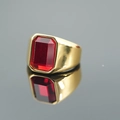 Polished gold male ring featuring a large rectangular red gemstone on a dark background - Gold Base Red Stone