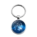 Macro view of Scorpio zodiac sign glass gem pendant keychain with silver ring - Cancer