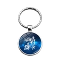 Detailed macro view of the silver constellation keychain with a blue zodiac glass dome - Virgo