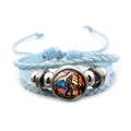 Detail of multi-layer blue leather bracelet featuring a Bigfoot glass dome charm - Blue