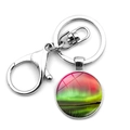 Close-up of Northern Lights glass dome keychain with polished silver metal lobster clasp - Aurora Style 12 (XSWX6737-12)