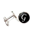 Detailed view of silver cufflinks with black round inlay and white letter G decoration - Letter G Style