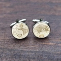 Close-up of vintage world map cufflinks with silver base on dark wood background - Classical Latin Map Style (XSWX6793-3)