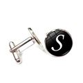 Detailed macro view of silver cufflink showing the letter S under round glass cabochon - Letter S Style
