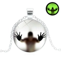 Luminous Halloween glass pendant necklace with glowing ghost silhouette on silver chain - Silver