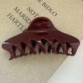 Macro detail of glossy wine red large hair claw clip on a minimalist textured book - Butterfly Back Style / Large Size 14CM / 83553 Wine Red