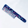 Macro detail of wide-tooth acetate comb featuring colorful marble patterns and anti-static texture - Multicolor Blue Glow