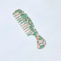Detail of wide tooth acetate comb featuring green and pink marble floral textures - Pink & Green