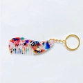 Detailed macro view of an acetate keychain comb with colorful floral tortoise patterns - Silver Keychain / Rainbow