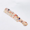 Detailed shot of retro acetate hair comb with marble texture and colorful mosaic pattern - Rainbow