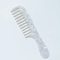 Detail of ergonomic handle and marble texture on acetate wide-tooth comb - 3mm Acetate / White