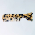 Macro view of portable mini acetate hair comb with tortoise shell texture and bear head shape - Light Leopard