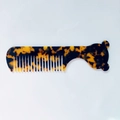 Macro detail of tortoise shell patterned hair comb with cute bear silhouette handle - Leopard Print