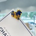 Detailed view of heart-shaped tortoiseshell hair clip on a minimalist display card - Leopard Print