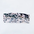Detail of tortoiseshell acetate hair comb showing the marble texture and fine comb teeth - Light Leopard