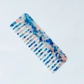 Detail view of wide-tooth acetate comb with blue and pink marble texture pattern - Dreamy Blue