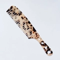 Detailed close-up of a vintage tortoiseshell wide-tooth comb with smooth acetate texture - Acetate 3mm Thickness / Light Leopard