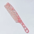 Detail of pink marble acetate hair comb with wide teeth and circular cutouts - Acetate 3mm Thickness / Pink Snowflake