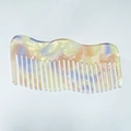 Close-up of wavy wide-tooth acetate hair comb with pastel marble textures - Light Yellow