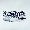 Close-up of black and white marble acetate hair comb with wavy edge and smooth teeth - Black and White