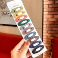 Set of 10 matte finish colorful oval BB hair clips on a white presentation card - Hollow Oval