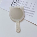 Detail of a cat-eared handheld mirror with a pearlescent white marble texture finish - 12cm*7.5cm / Mermaid Color